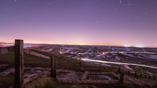 Mountain road city lights night - a city in the distance free wallpaper