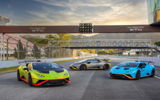 Three colored sports cars race - a race track free wallpaper