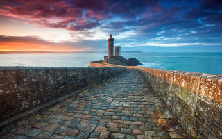 Stone lighthouse rocky shore sunset - a stone walkway free wallpaper for desktop