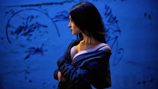 Woman black dress blue wall 2 - a blue wall free wallpaper