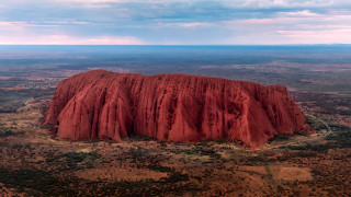 Desert rock formation australian tonalism - a large rock formation in the middle of a desert area free wallpaper