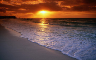 Sunset ocean boat beach waves - a sunset over the ocean free wallpaper