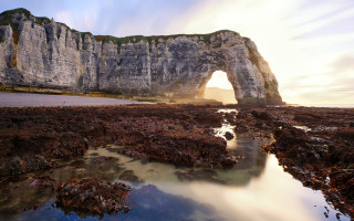 Large arch rock landscape city - a large rock formation free wallpaper for desktop