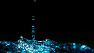 Blue water splash glowing macro - a water splash free wallpaper