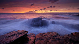 Sunset rocky beach waves cloudy - rich moody colour free wallpaper