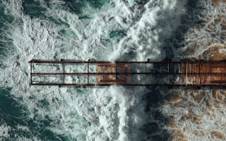 Rusty pier ocean birdseye microscopic - wave free wallpaper