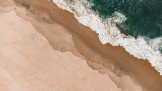 Aerial view beach waves surfboard - a person riding free wallpaper