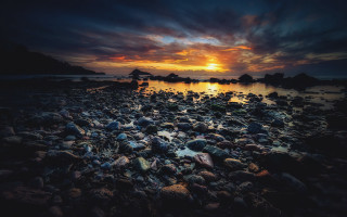 Sunset rocky beach cloudy sky - a sunset over a rocky beach free wallpaper