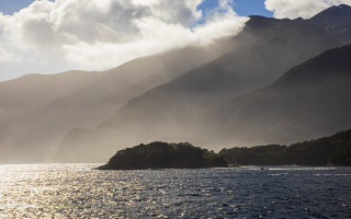 Mountain reflection boat ocean sky - volumetric light free wallpaper for desktop