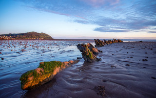 Bascove beach rocks water hill - a hill in the distance free wallpaper