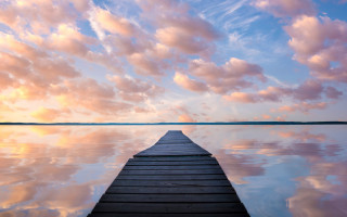 Dusk dock pink clouds minimalist - a body of water under a cloudy sky free wallpaper