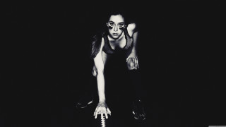 Woman black top holding white - a white object free wallpaper