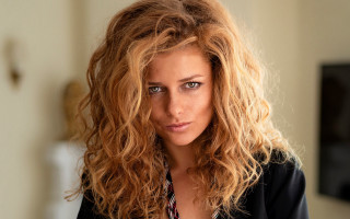 Serious blonde curly wavy portrait - her face and shoulders free wallpaper
