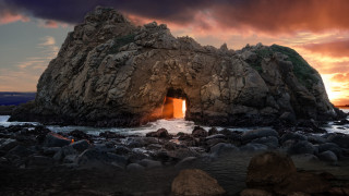 Rock formation light water beach - a large rock formation free wallpaper