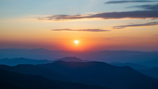 Sunset mountain bird sky cityscape - a sunset over a mountain range free wallpaper