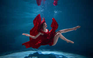 Woman red dress underwater floating - a pool of water free wallpaper