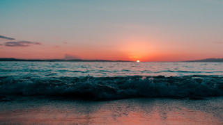 Sunset ocean waves island sky - a small island in the distance free wallpaper