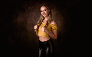 Woman yellow top black background - a yellow top free wallpaper