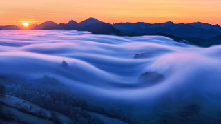 Sunset mountain sea clouds setting - mist free wallpaper