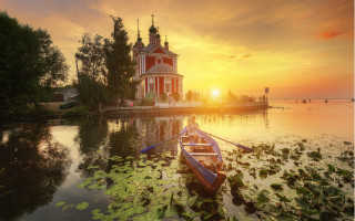 Boat church dock lily pads - the water and a sunset in the background free wallpaper