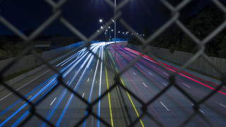 Night highway fence streetlight cityscape - a street light in the background free wallpaper