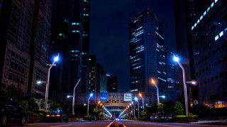 City street night neon skyline - the background and a street light in the foreground free wallpaper