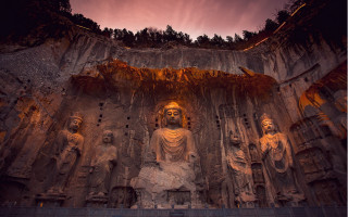Buddha statues cave sunset flame - a sunset in the background free wallpaper for desktop