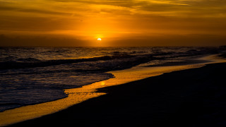 Sunset ocean waves beach person 2 - the beach in the distance free wallpaper