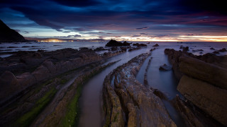 Sunset rocky beach water cloudy - a long exposure of a sunset over a rocky beach free wallpaper