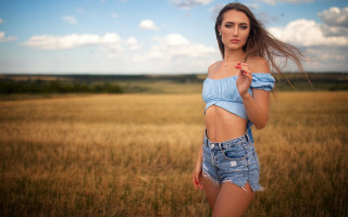 Woman blue top field wind 2 - a field of grass and grass free wallpaper