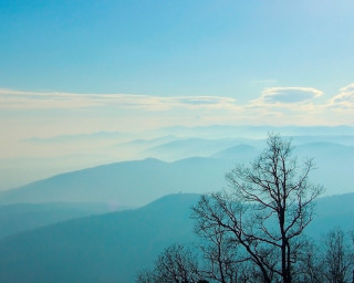 Mountain range trees clouds sunset 2 - a view of a mountain range free wallpaper