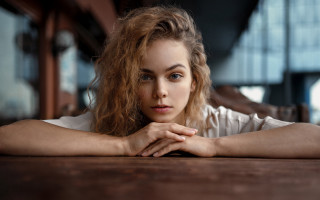 Woman long hair sitting table 2 - free portrait wallpaper for desktop