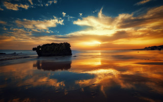 Sunset beach island clouds dusk - a small island in the middle of the water free wallpaper