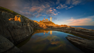 Lighthouse rocky cliff ocean sunset 13 - a reflection free wallpaper for desktop