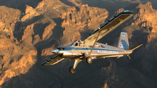 Small airplane mountain range sunset - the background and a sky line in the foreground free wallpaper