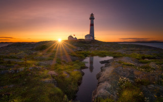 Lighthouse rocky outcrop sunset water - a rocky outcropping free wallpaper