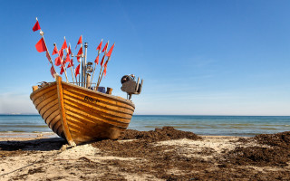 Beach boat flags ocean sky - the beach near the ocean free wallpaper