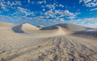 Desert sand dunes clouds ocean - a few sand free wallpaper