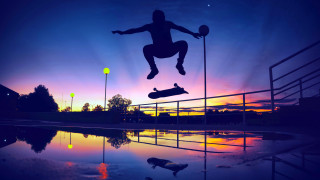 Skateboarder jumping sunset reflection graffiti - a sunset background free wallpaper