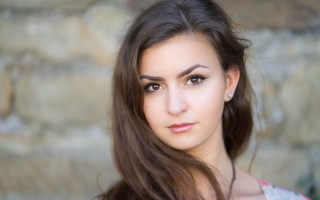 Woman longhair pinkshirt stonewall portrait - free portrait wallpaper for desktop