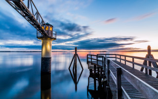 Pier lighthouse sunset clouds reflection - the sky and water free wallpaper