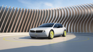White car driving curved building - design free wallpaper