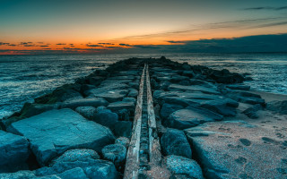 Pier rocky beach sunset cloudy - a long wooden pier free wallpaper