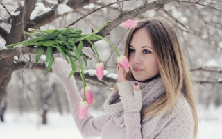 Blonde woman pink flowers snow - her hand and a tree in the background free wallpaper