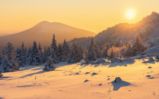 Snowy mountain sunset trees beach - a yellow sky free wallpaper
