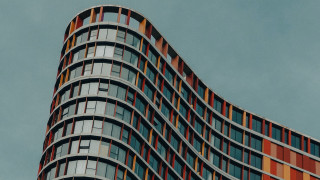 Tall curved building abstract sculpture - bold shape free wallpaper