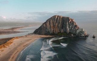 Large rock beach ocean boat - top of a beach next free wallpaper