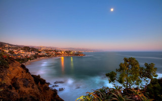 City ocean cliff full moon - a full moon in the sky free wallpaper for desktop