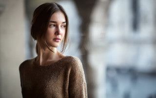 Woman brown sweater serious portrait 2 - her face and shoulder free wallpaper