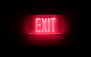 Red exit sign dark lit - institutional free wallpaper